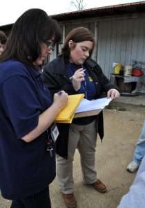McLain, Miss., Feb. 22, 2013 -- FEMA Preliminary Disaster Assessment (PDA) Representative Karrie Beardall and Mississippi Emergency Management Agency District 1 Area Coordinator Jennifer Cobb-Willis write down information provided to them by local residents. PDA teams verify the damages with visits to the damaged homes. Greene County has requested a FEMA disaster declaration due to the damages from the flash floods which accompanied the tornado event February 10th. Photo by Marilee Caliendo/FEMA (National Archives ID: 24475833)